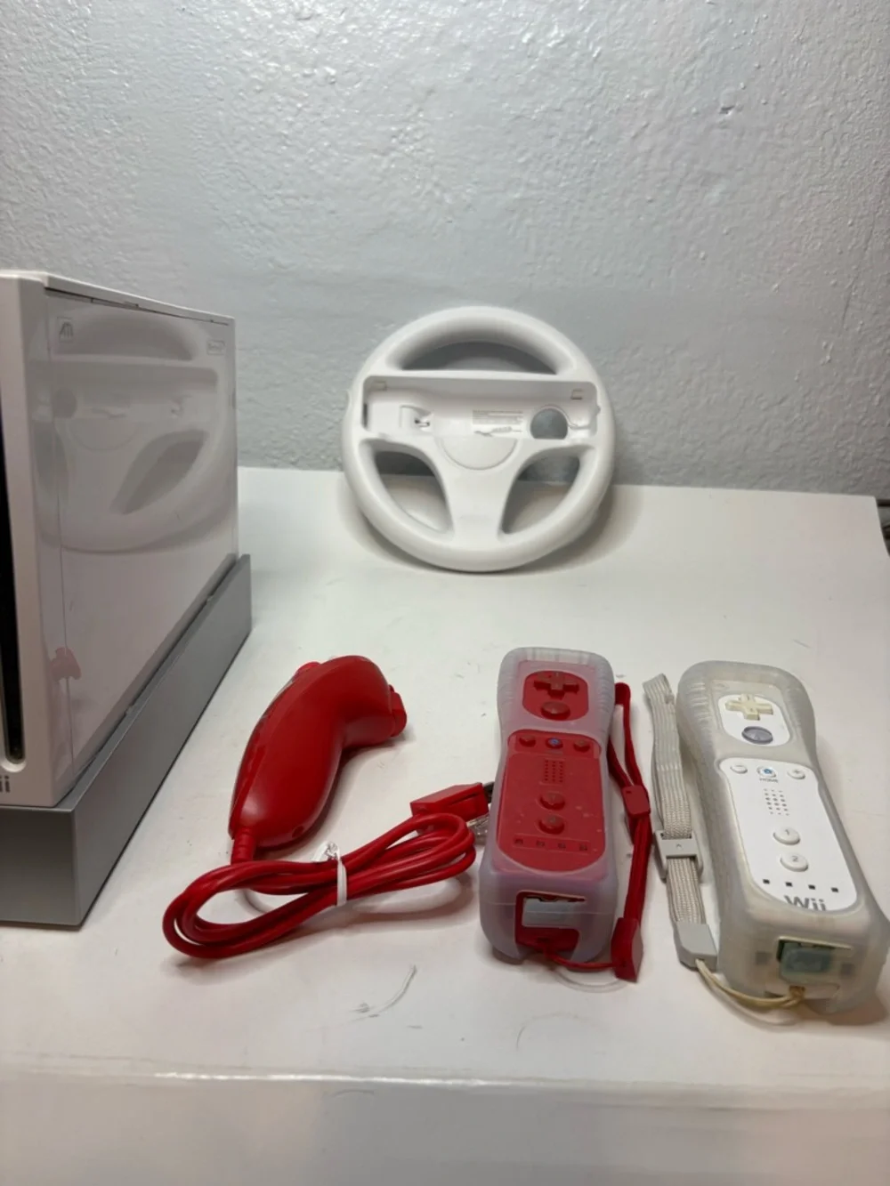 Nintendo White Wii Console with Red Remotes and Wheel